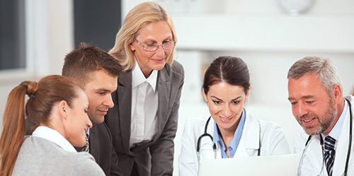 Nurse administrator talks to a group of doctors