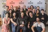 19 YouTube creators posing in front of a YouTube Creator Collective banner