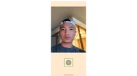 A screenshot of the Guided Frame app open to show a man looking into the camera, unsmiling, taking a selfie. His face is centered and circled.