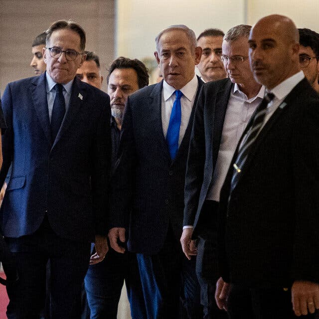 The Israeli prime minister, flanked by other people.
